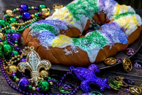 gâteau roi entouré de décorations de mardi gras