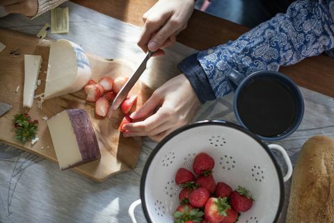 Hacher les fraises et le fromage sur une planche en bois